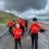 children walking on beach after surfing session