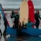 Adults posing with surf board on beach