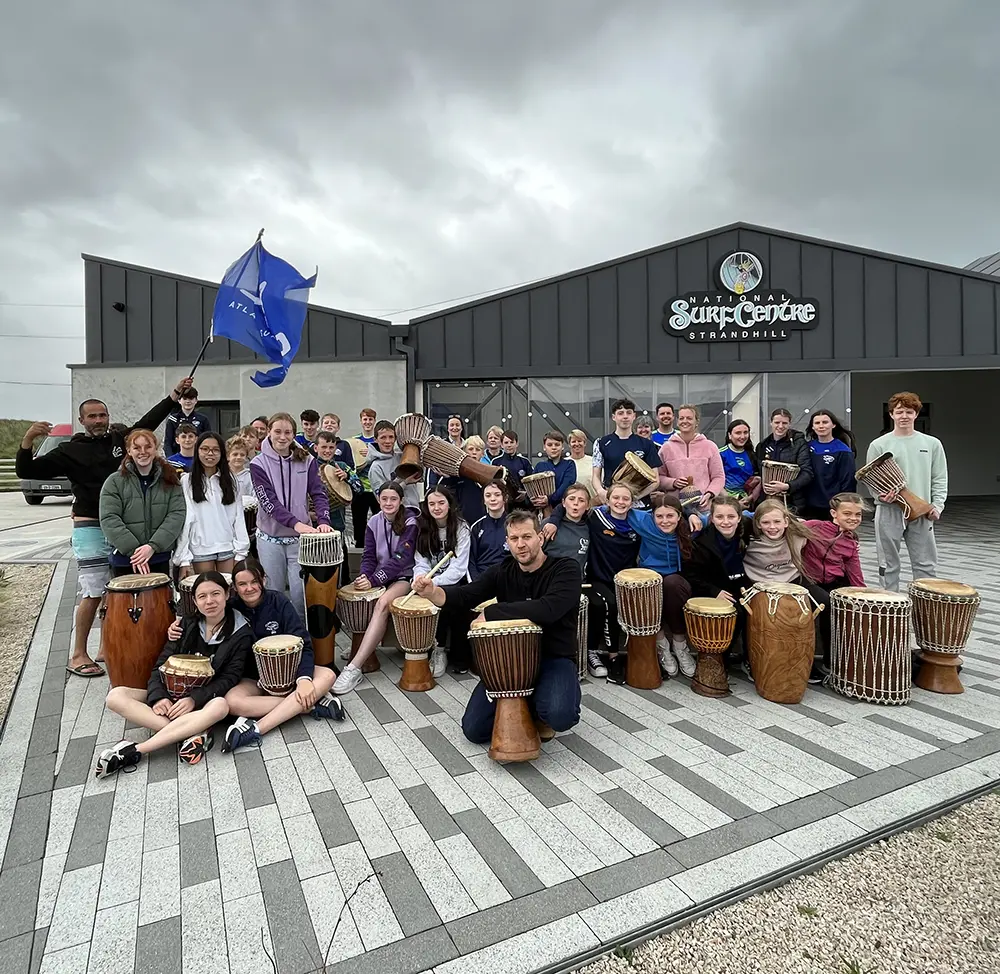 Group of schoolchildren posing with drums