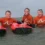 Three members of a family posing with their surf boards in the ocean