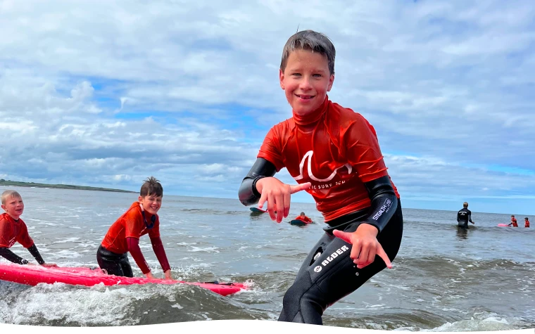 A boy surfing in ocean