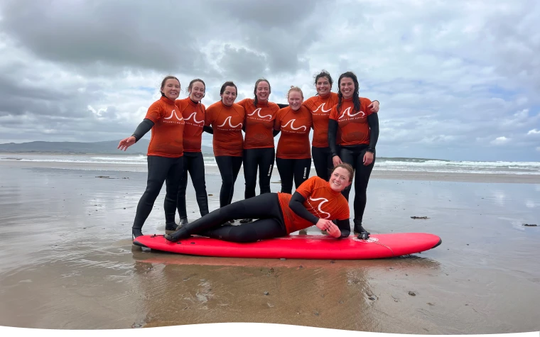 Group of female posing with surf boards