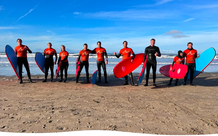 corporate group posing with surf boards